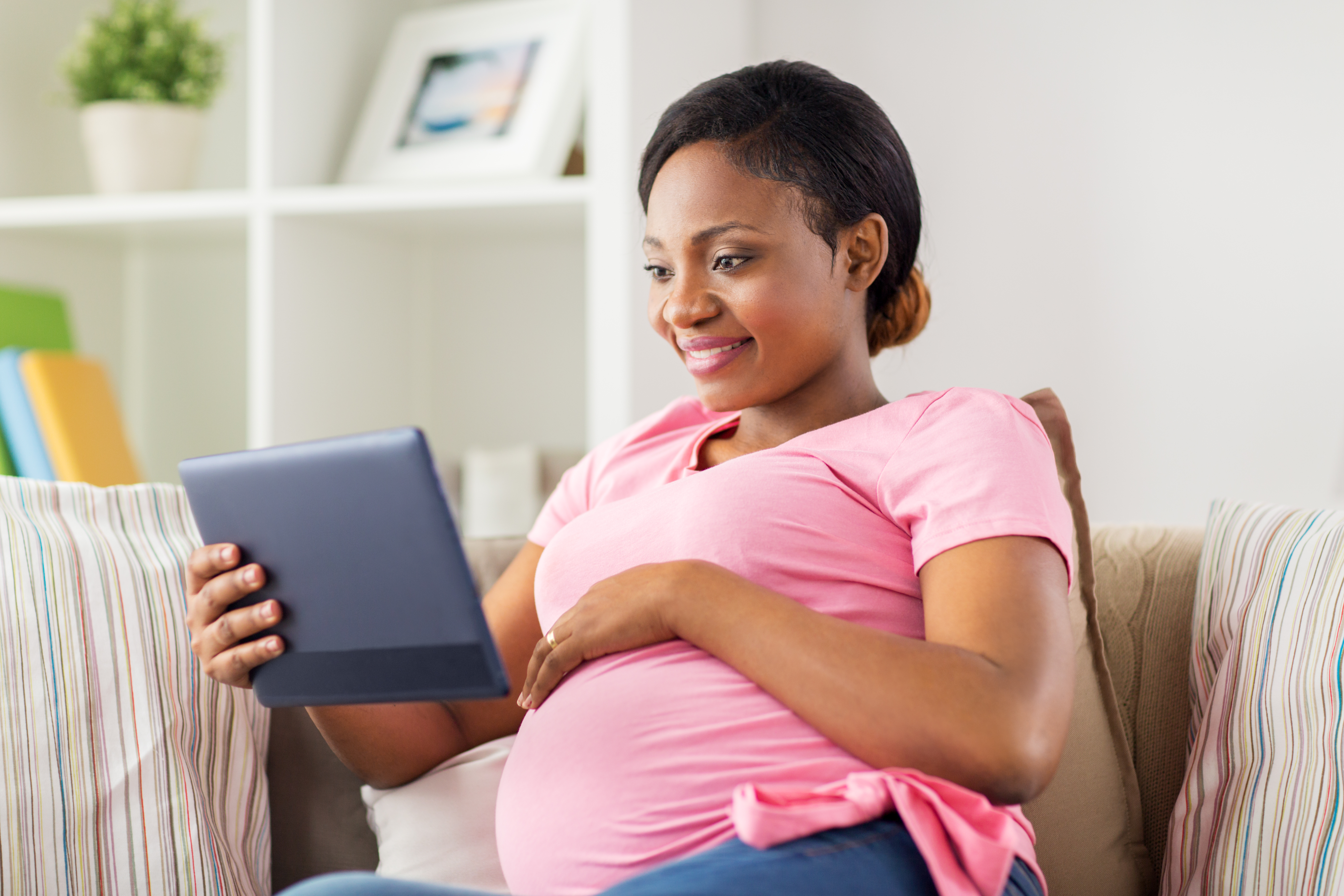 Client enjoying a Prenatal Breastfeeding Class on their tablet while resting in their home
